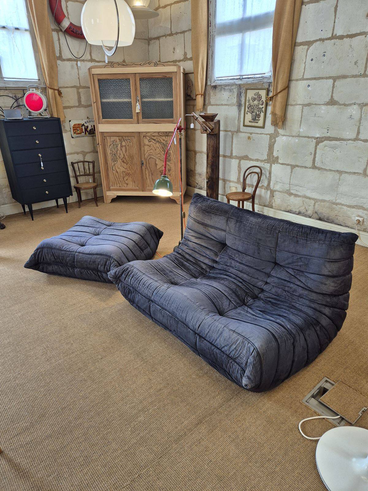 Togo sofa by Ligne Roset and its pouf from the 1970s.