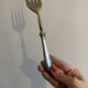 Engraved meat fork in silver and gold metal