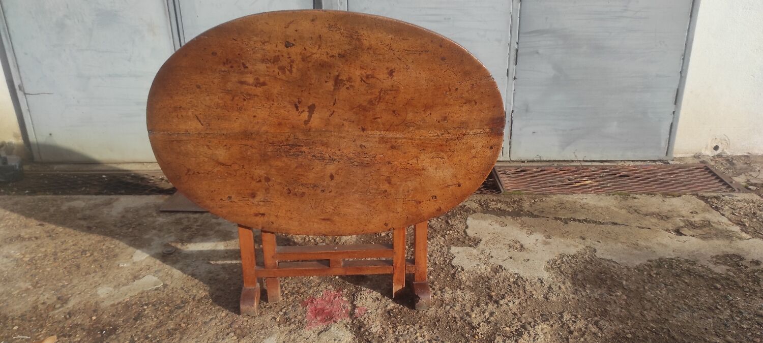 Old rustic oval folding wooden farmhouse table