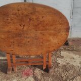 Old rustic oval folding wooden farmhouse table
