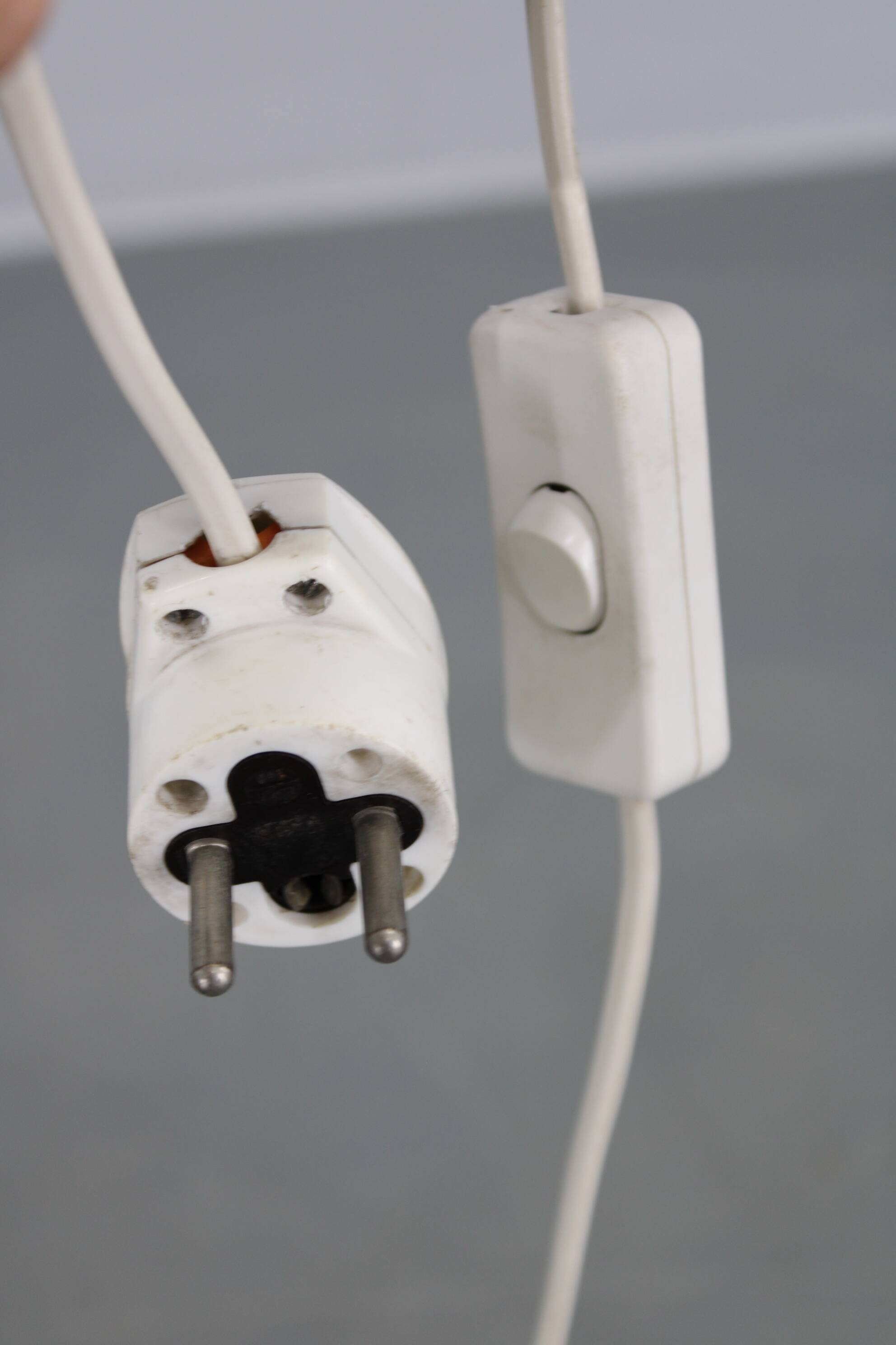 Mid-century modern floor lamp on iron legs with plastic shade and wood accent