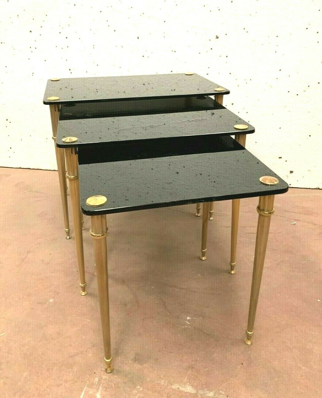 Pull out tables in brass and black glass XX century
