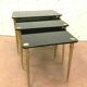 Pull out tables in brass and black glass XX century