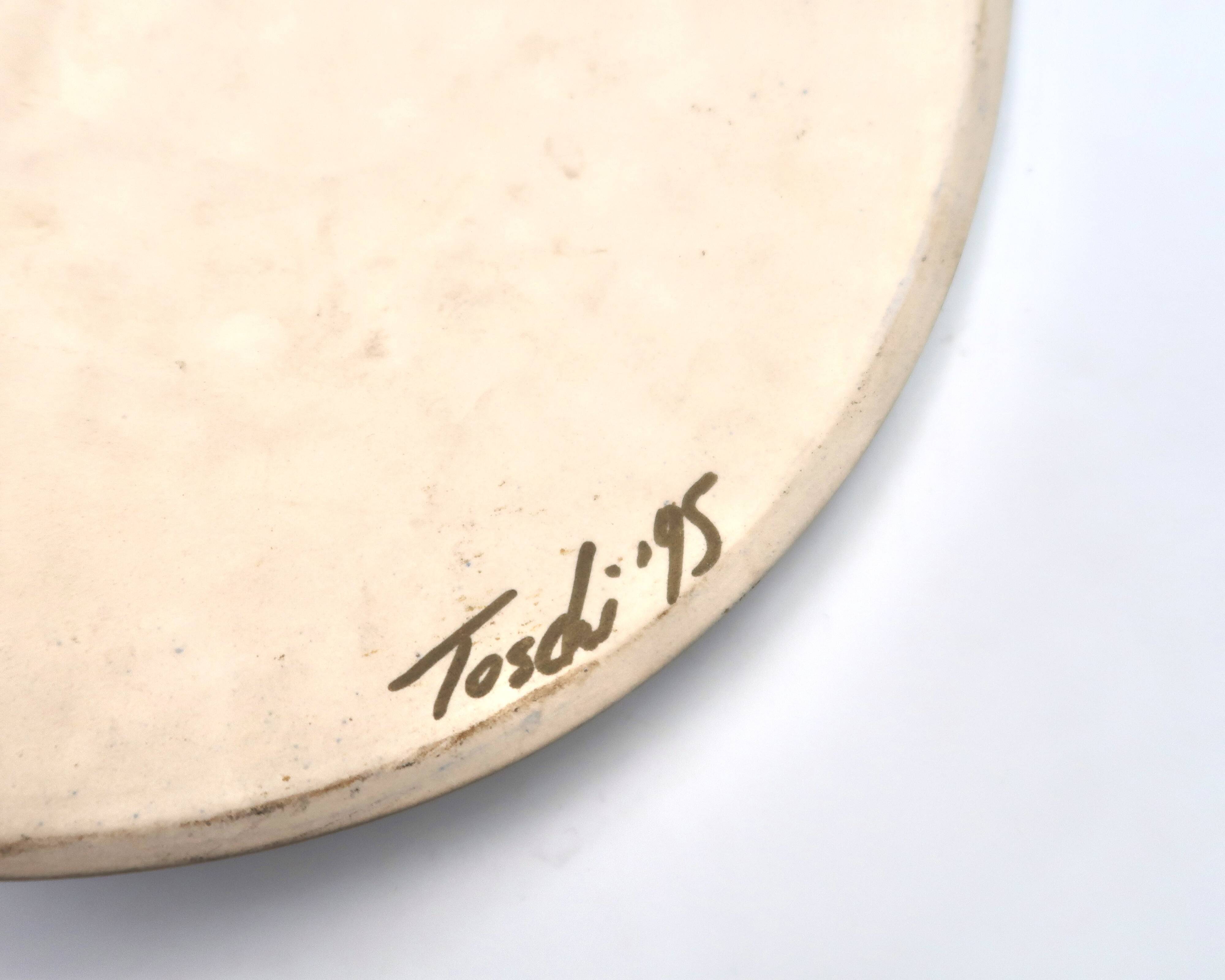 Relief mural signed in ceramic, sun with blue and gold face, 1990s.