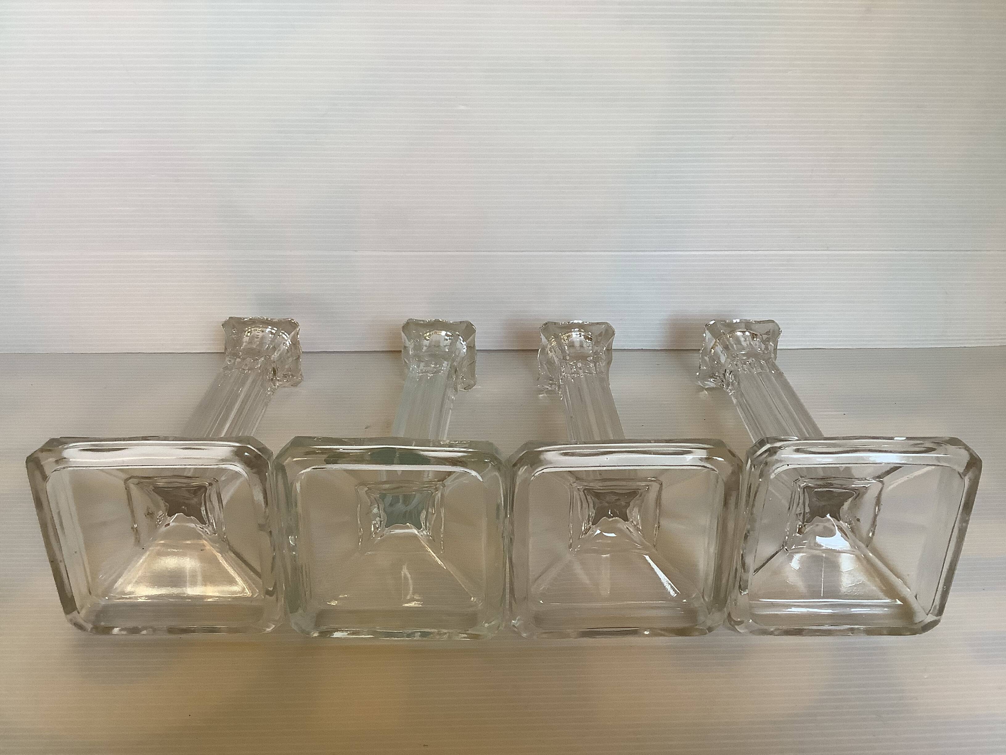 Four old square molded glass candlesticks