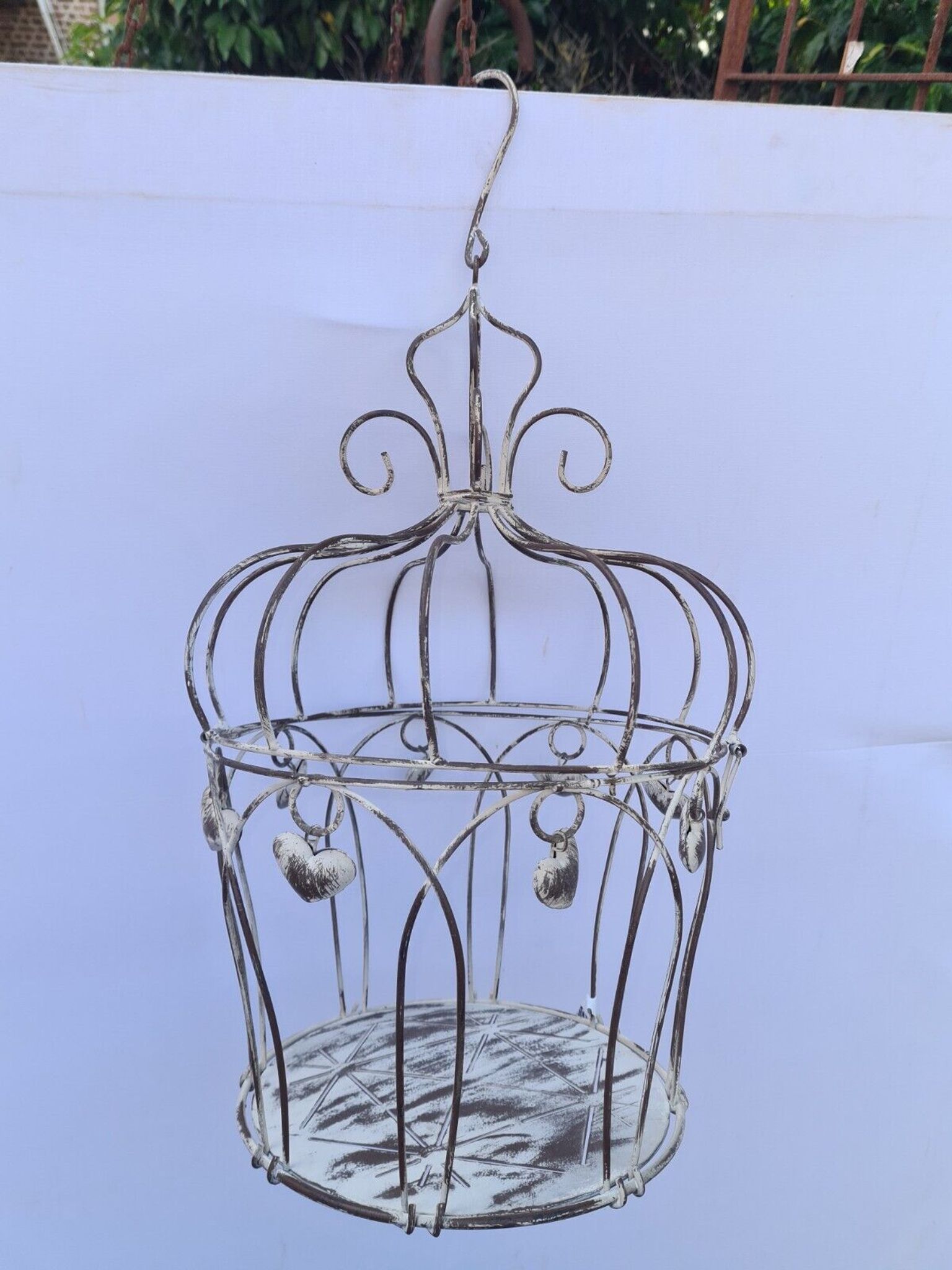 Decorative bird cage with iron hearts