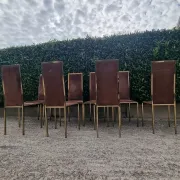 8 vintage 1970s chairs in brass and velvet with high backs.