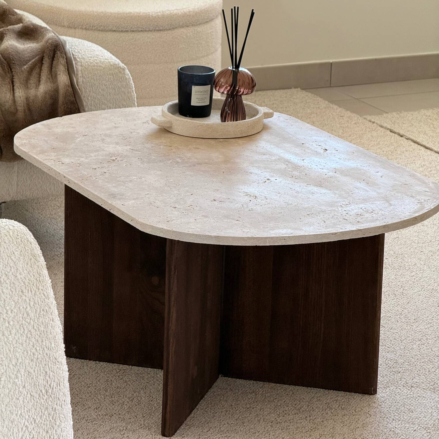 Oval coffee table in travertine and dark oak.