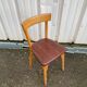 Chaise Baumann assise skaï