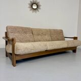 Old 3-seater sofa in solid wood, Maison Regain design, from the 70s.