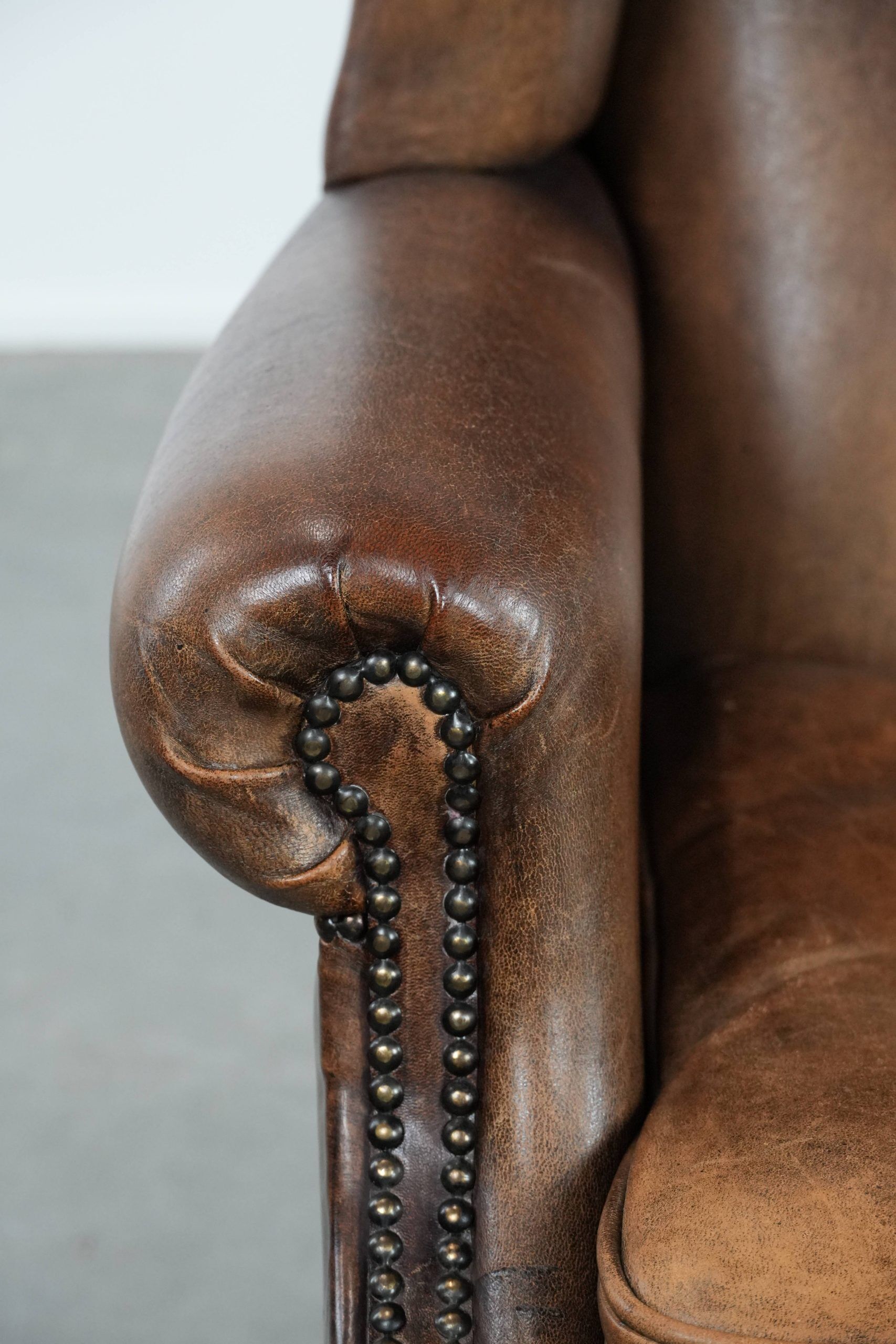 Warm, cosy and comfortable vintage sheepskin ear armchair with character