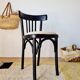 Curved black wooden bistro chair with striped seat