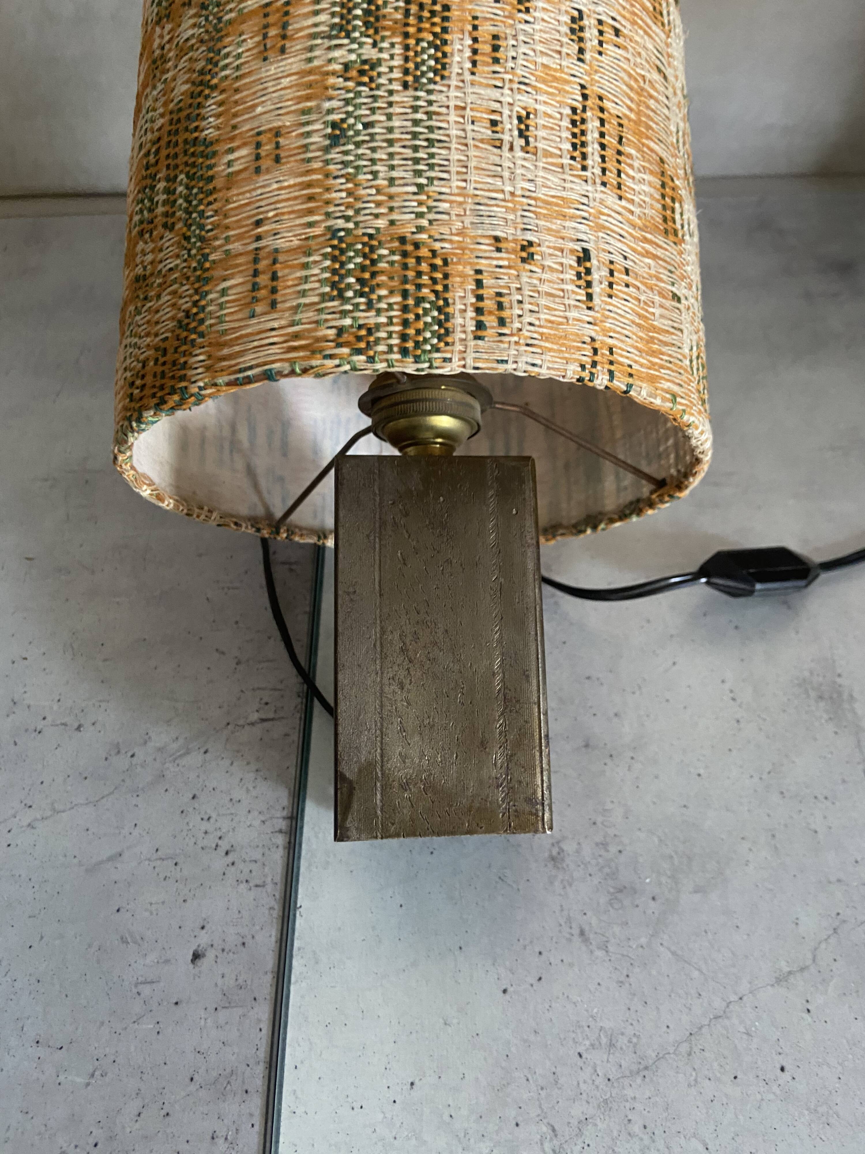 Small modernist table lamp with hand-woven shade.
