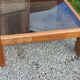 Coffee table from Regain in solid elm with a smoked glass top.