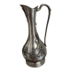 Carafe The House of Tin surrounded by ivy branches.