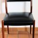 Four antique Scandinavian-style chairs made of solid wood and faux leather.