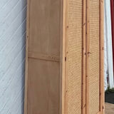 Renovated antique wardrobe in raw wood and caning.