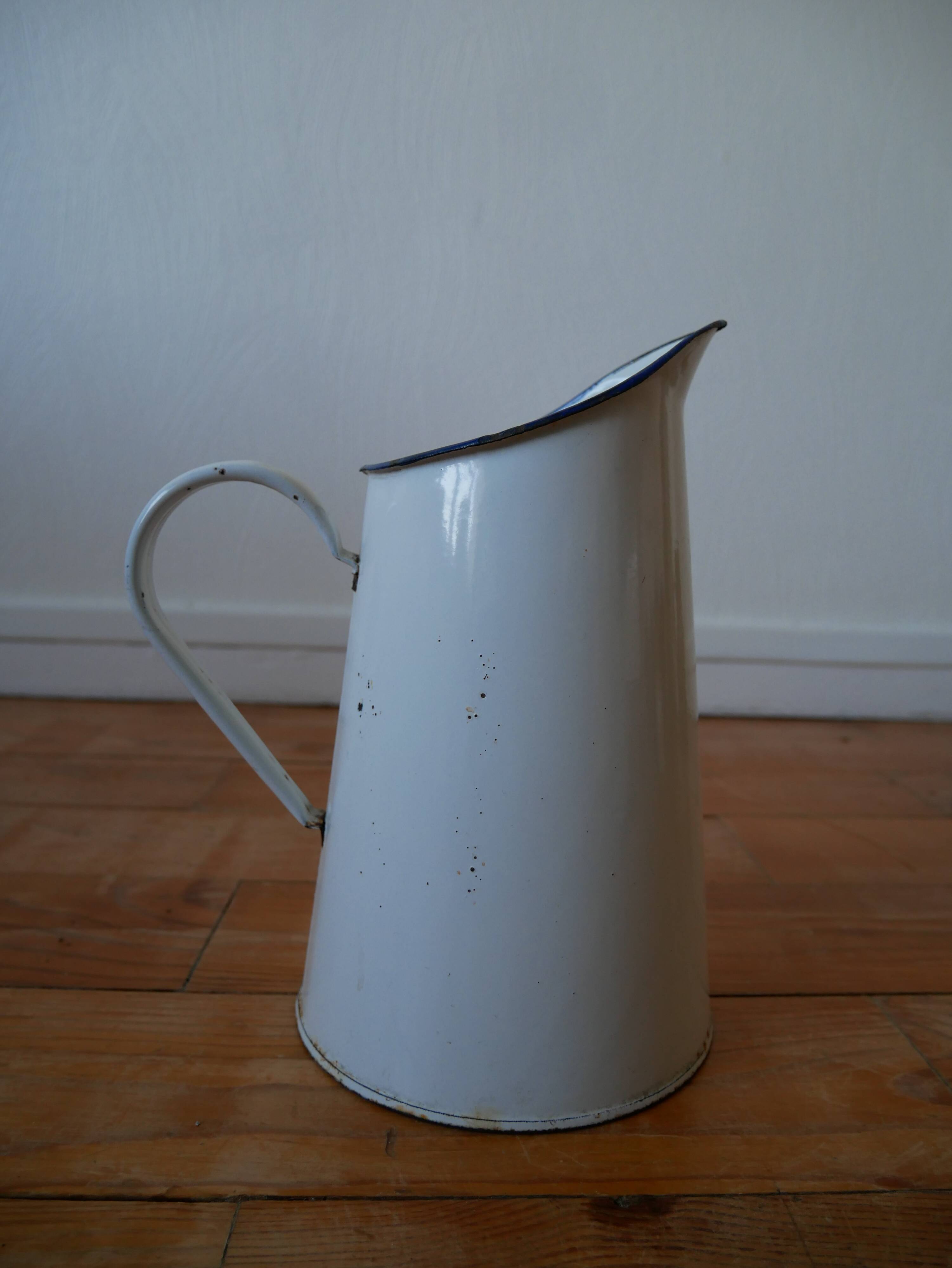 White enamelled metal broc