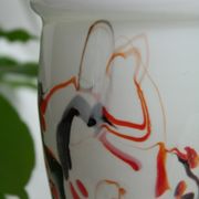 Corolla vase in white opaline with orange-brown patterns.