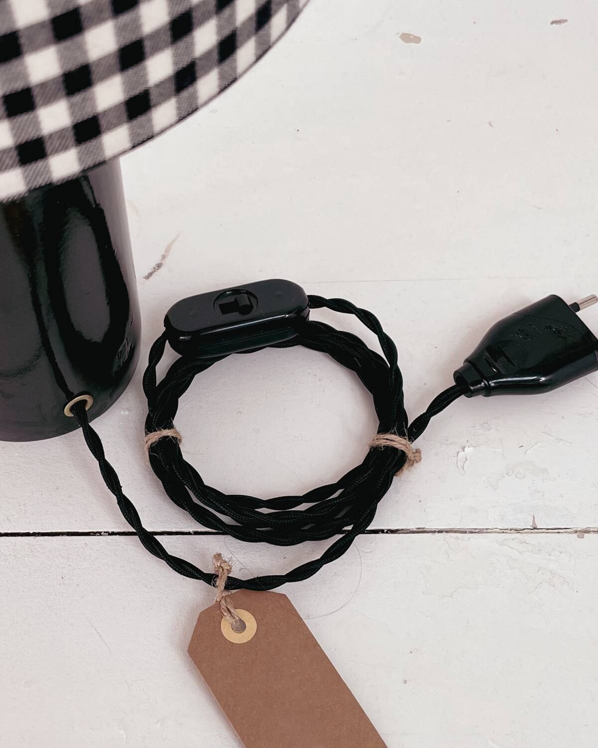 Black earthenware lamp and gingham lampshade