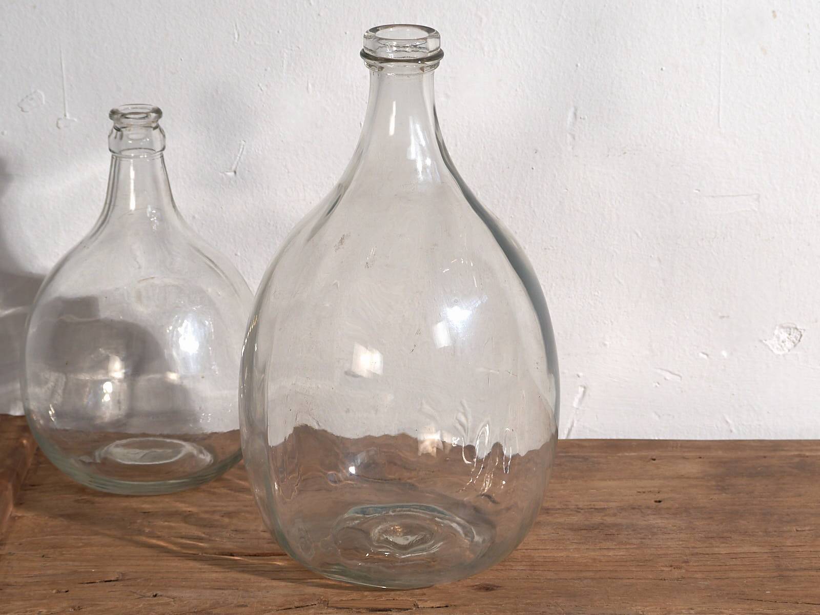 Antique glass demijohns (c.1920). Set of 2 pieces