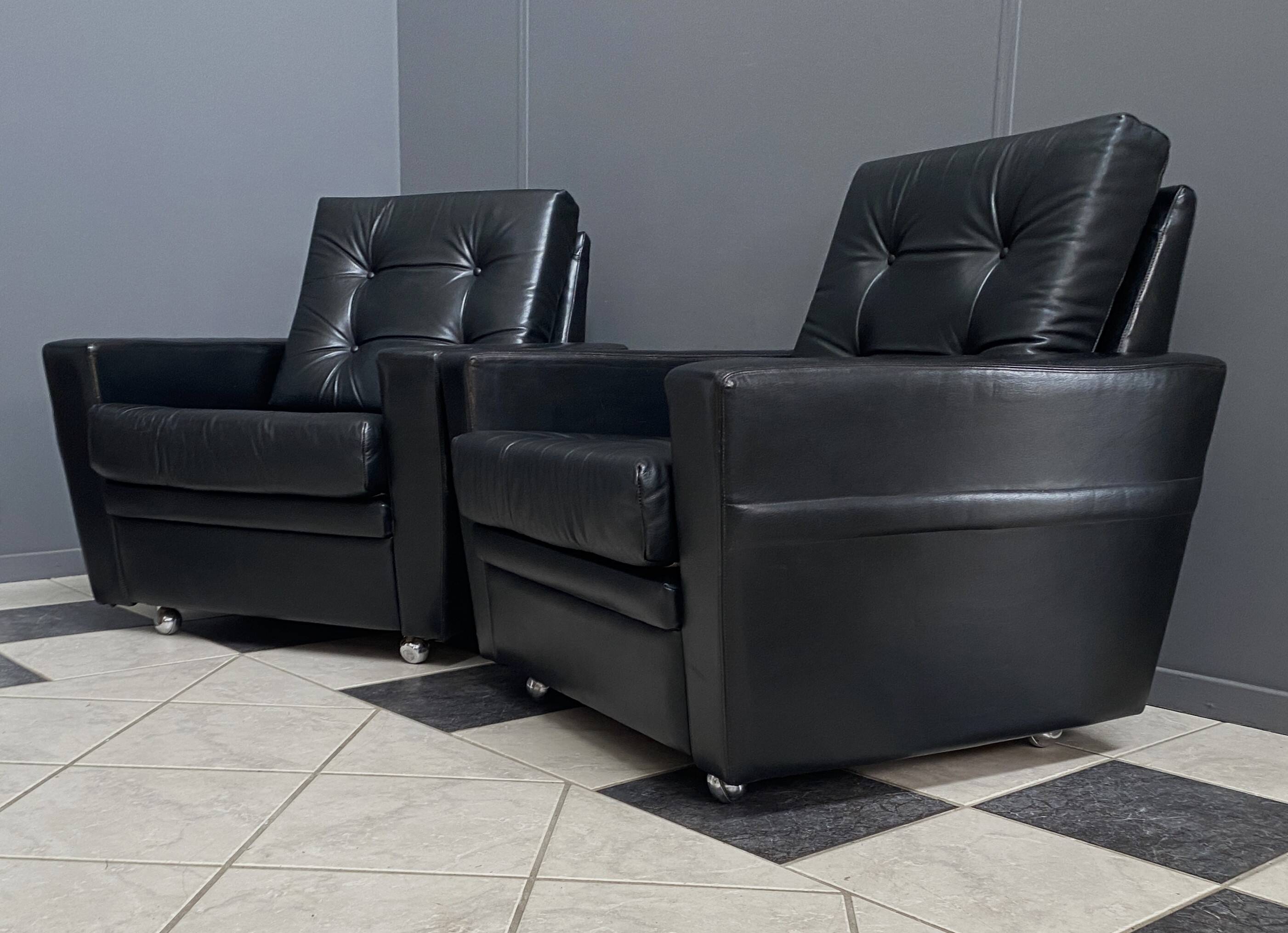 2 Black leather arm chairs 1960s on wheels