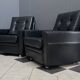 2 Black leather arm chairs 1960s on wheels