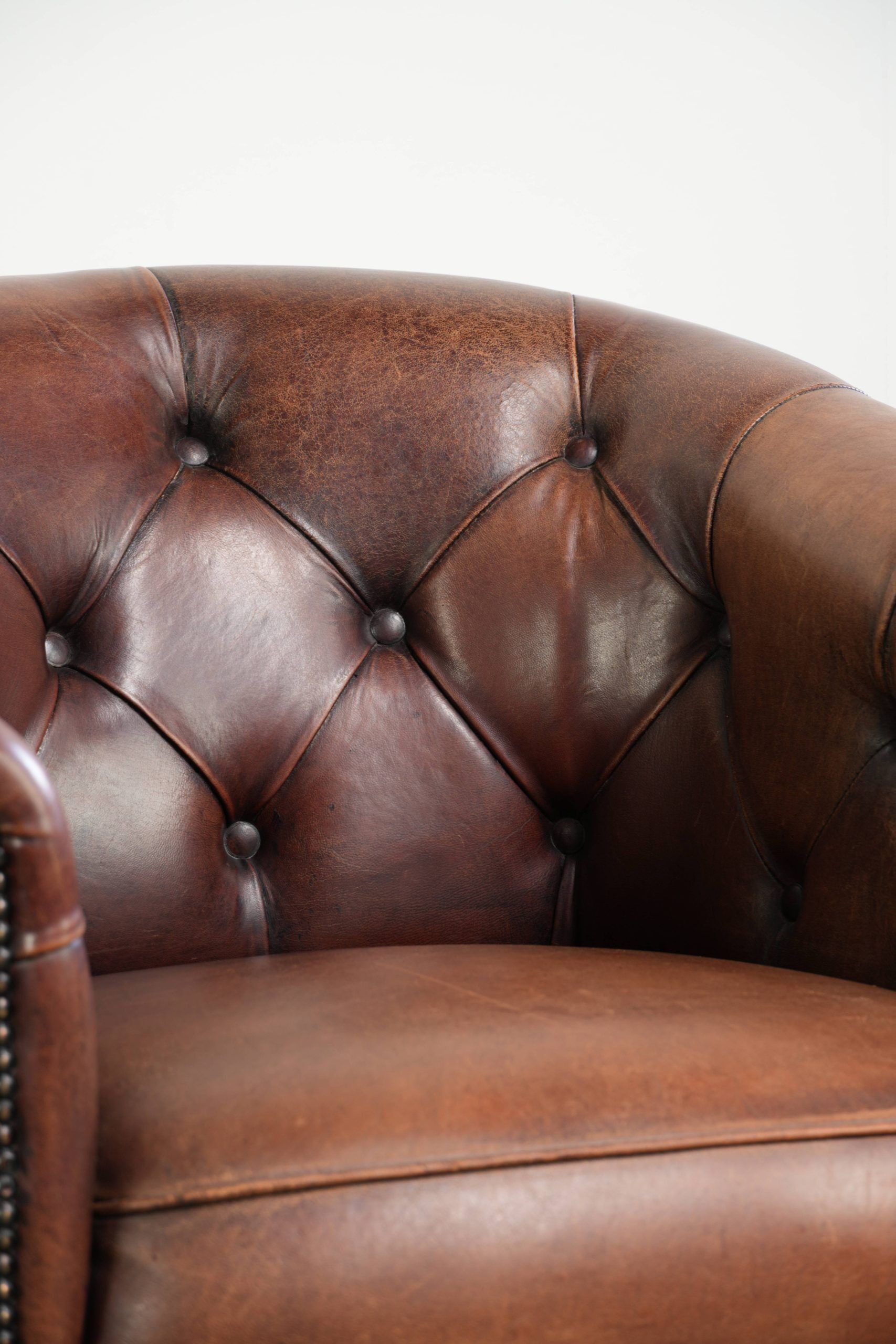 Characterful set of sheepskin club armchairs in English chesterfield style