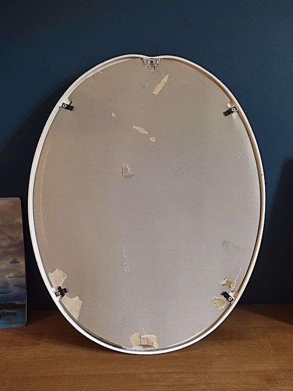 Oval mirror patinated white enamelled metal frame
