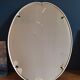 Oval mirror patinated white enamelled metal frame