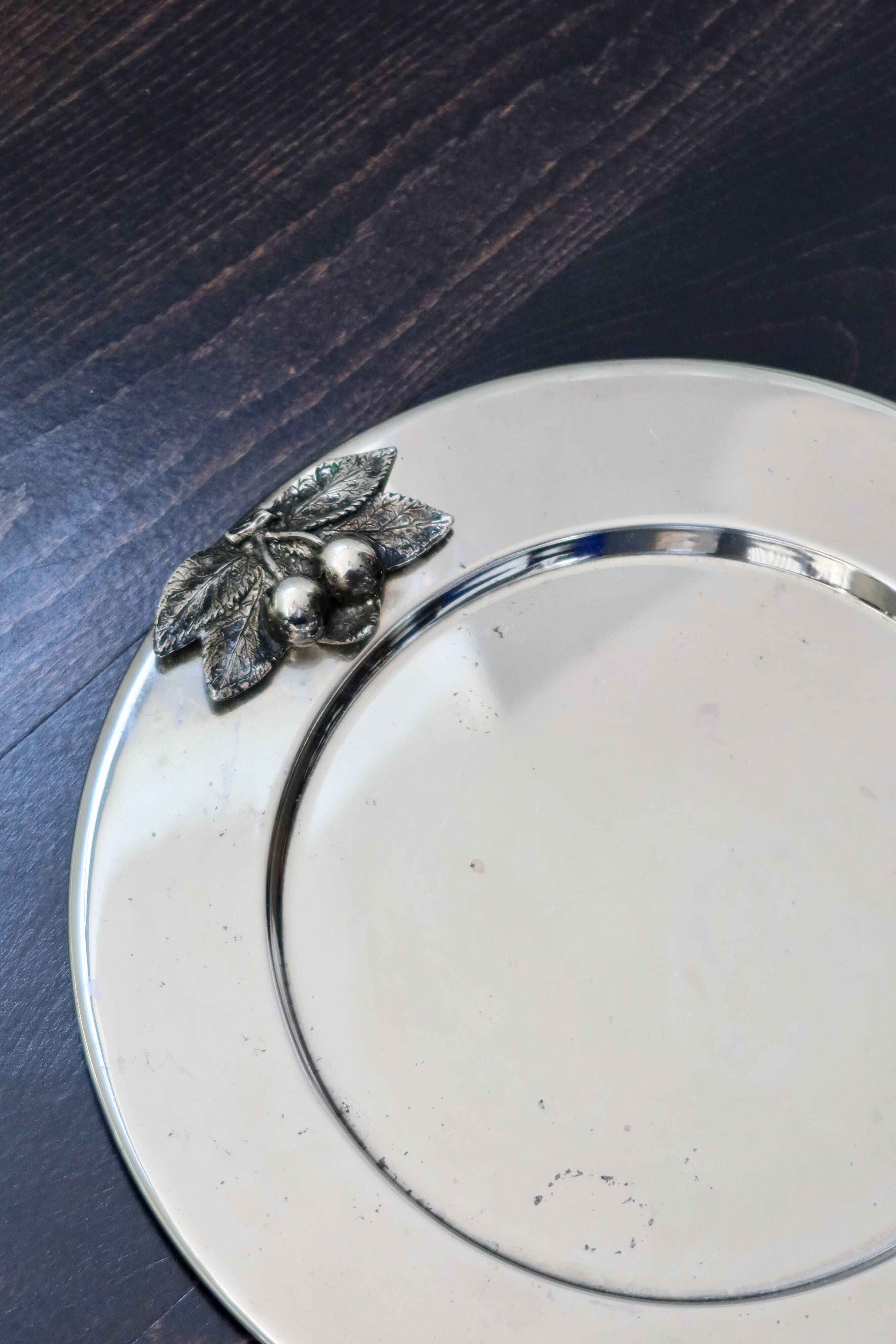 Vintage silver-plated round service tray with embossed cherries.