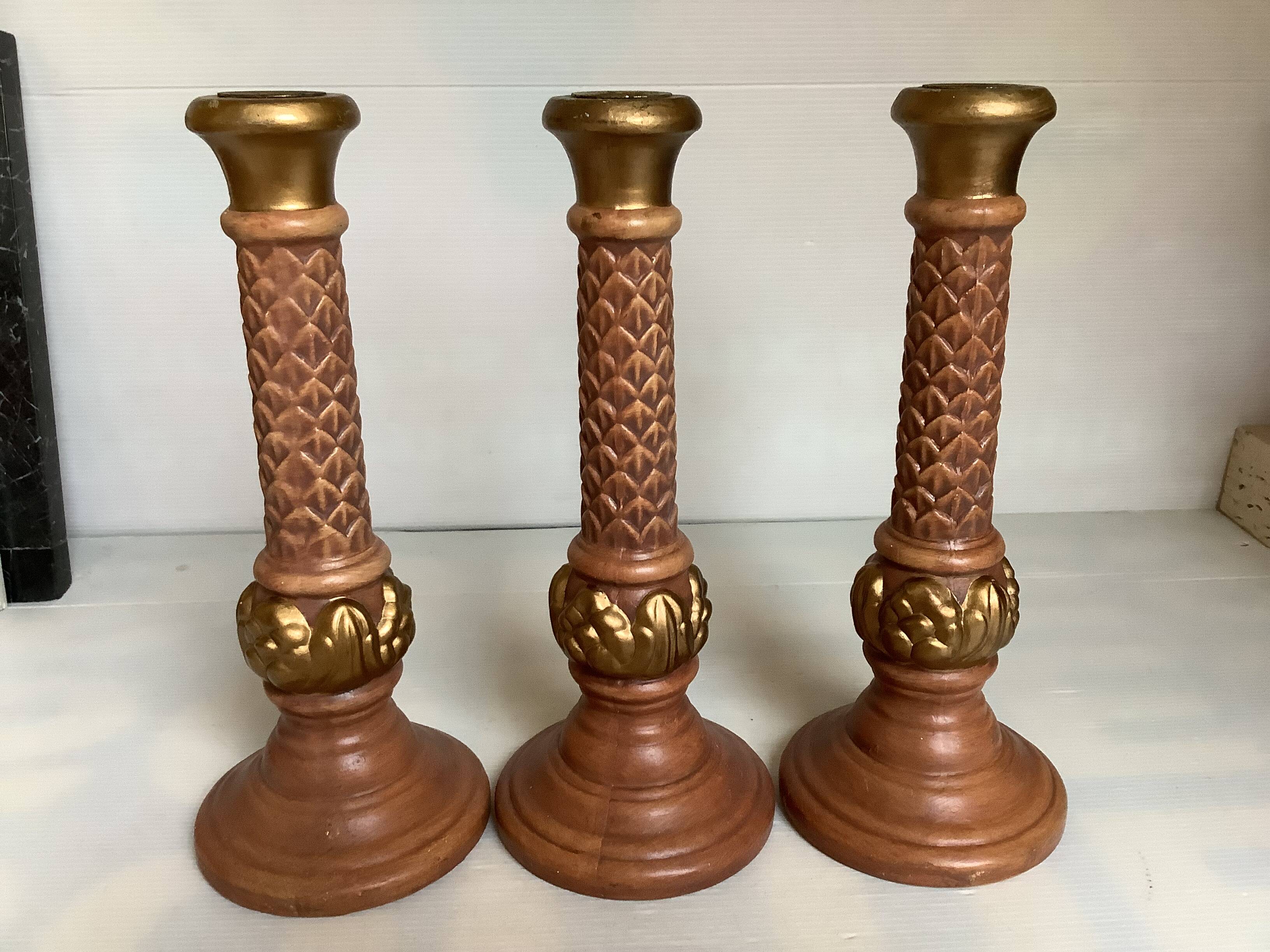 Trio of large brown and gold candlesticks