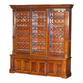 Monumental high Victorian library in solid mahogany with astral display cases.