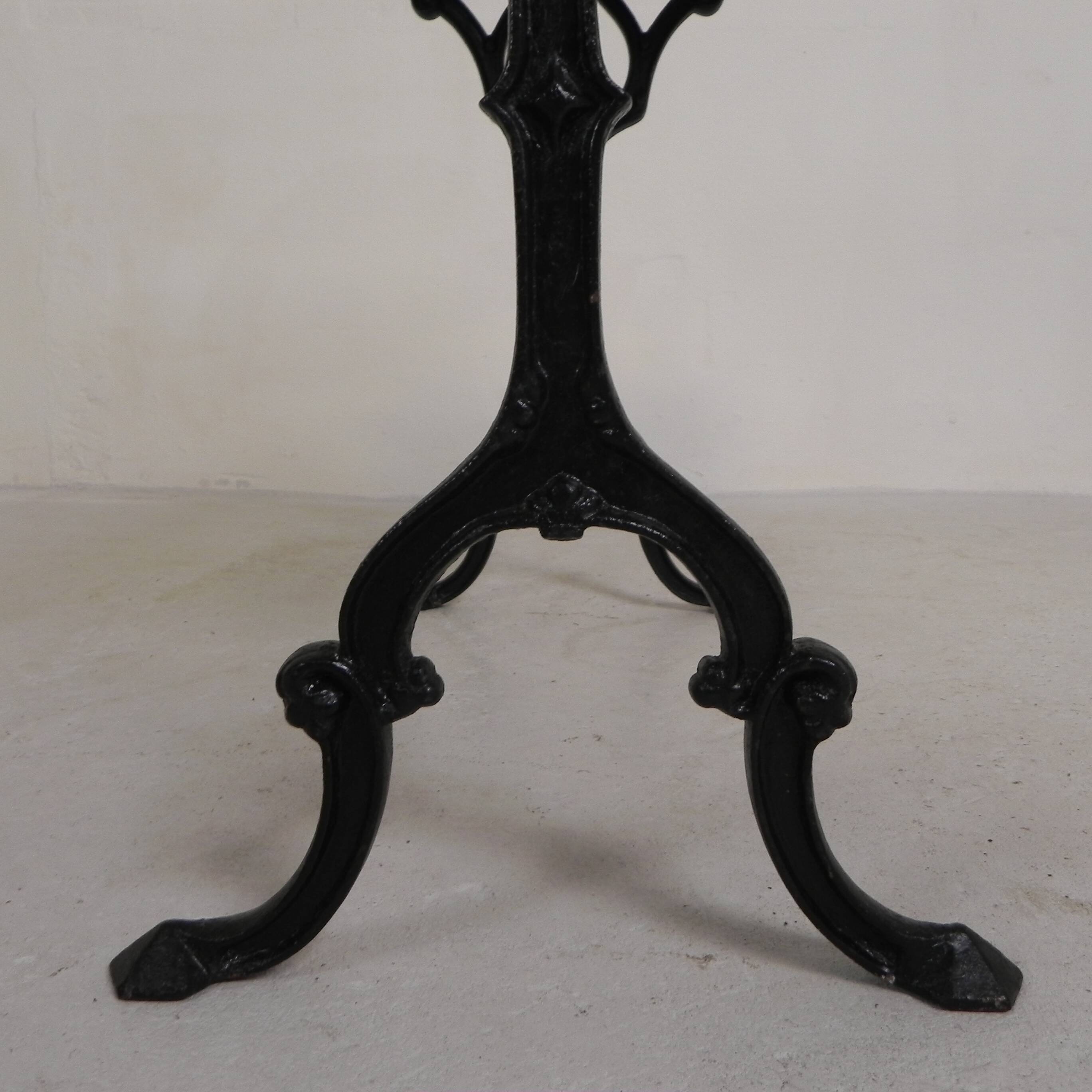 Bistro table with an oak top on a cast iron base, 1930s.