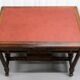 19th-century carved walnut desk with a leather top.