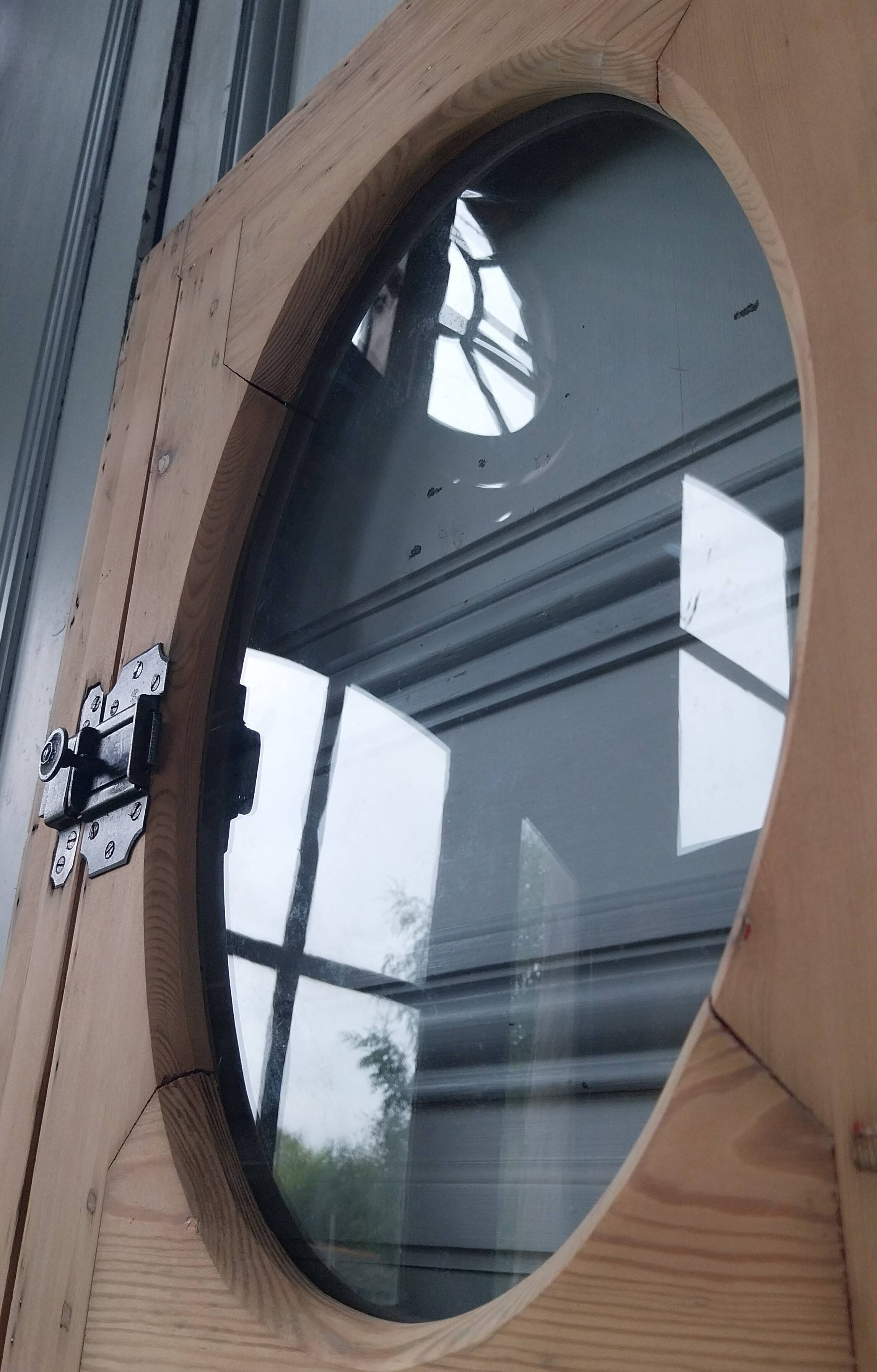 Old bullseye window with oval glass