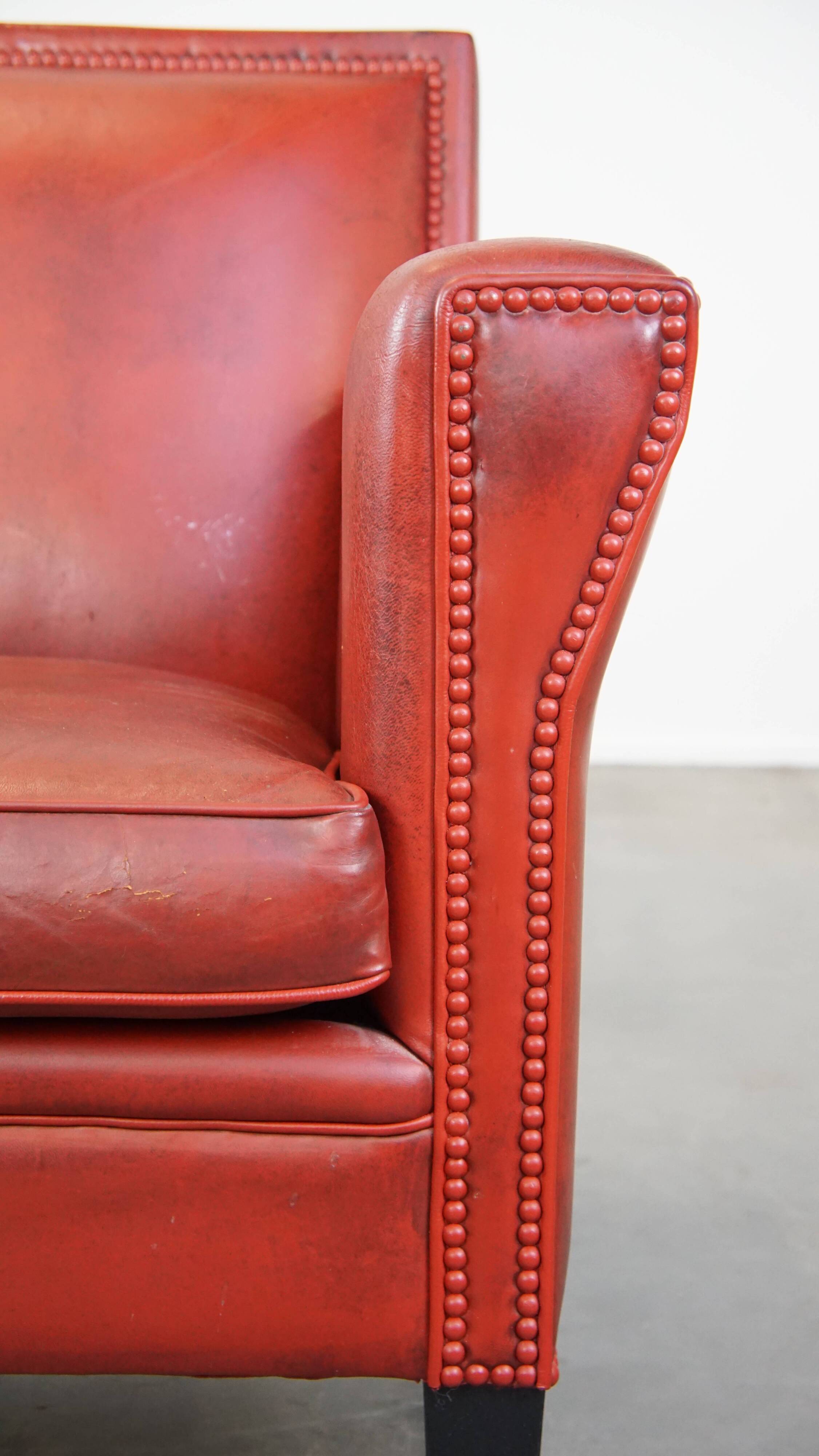 Red-painted armchair made of sheepskin leather