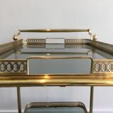 Neoclassical style rolling table in brass with blue glass tops
