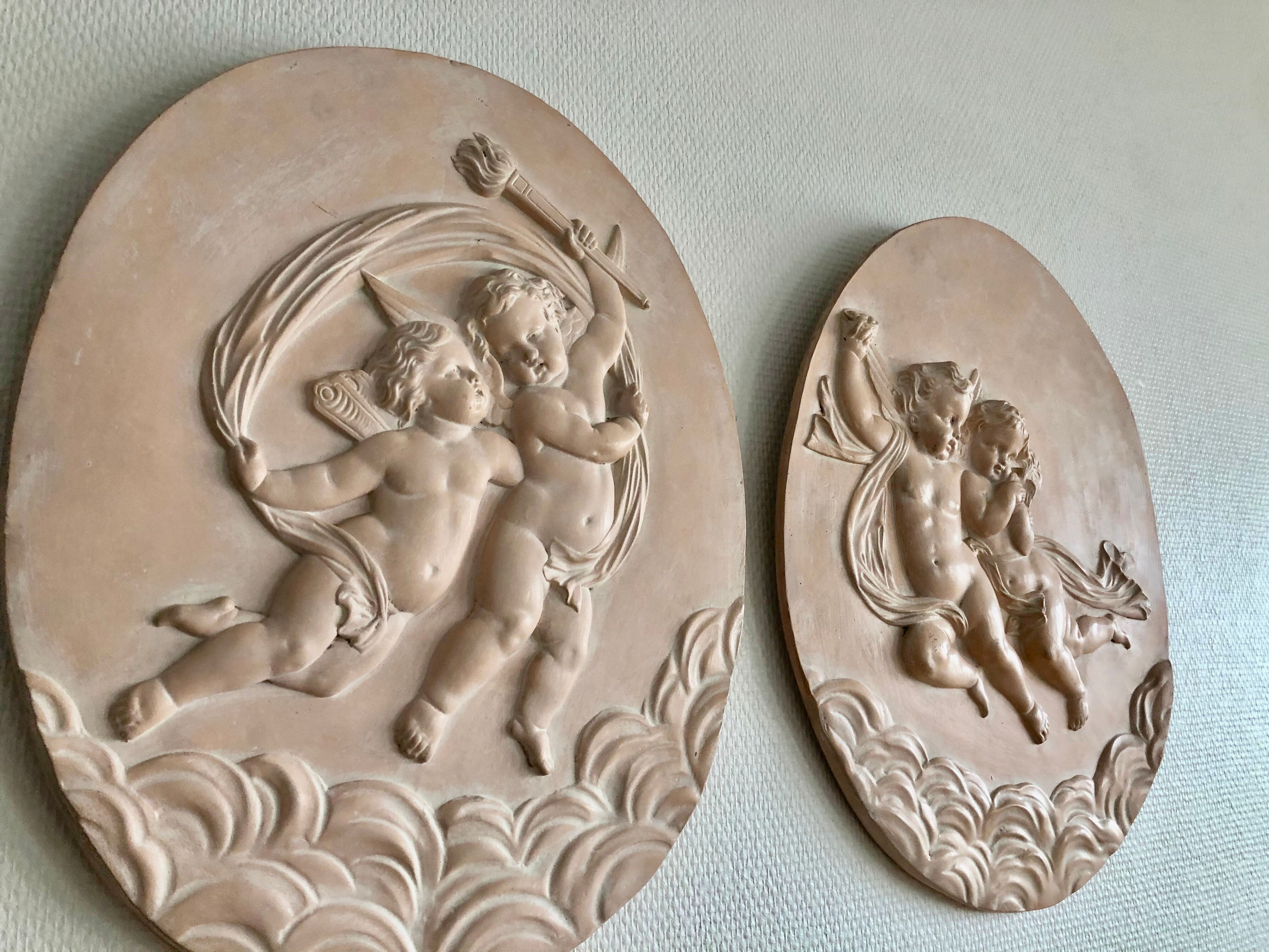Pair of putti medallions
