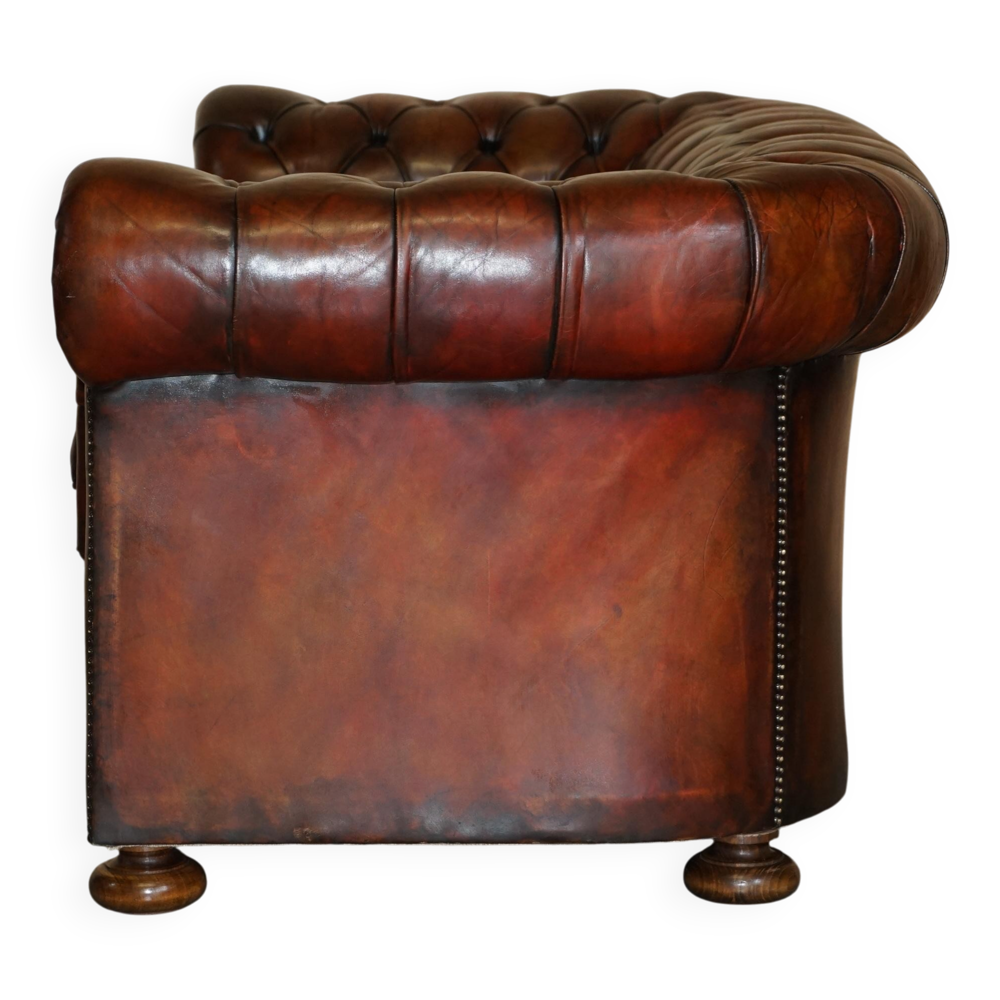 Pair of restored antique Chesterfield sofas in Boudreaux leather.