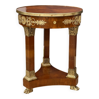 Circular gueridon empire of the 19th century in marquetry ornamented with gilt bronze