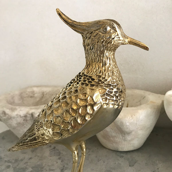 Crested bird in golden brass