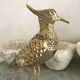 Crested bird in golden brass