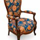 Restored Louis-Philippe cabriolet armchair, blue and orange floral fabric.