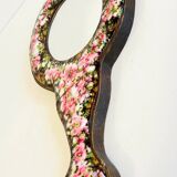 Vintage enameled metal hand mirror on wood