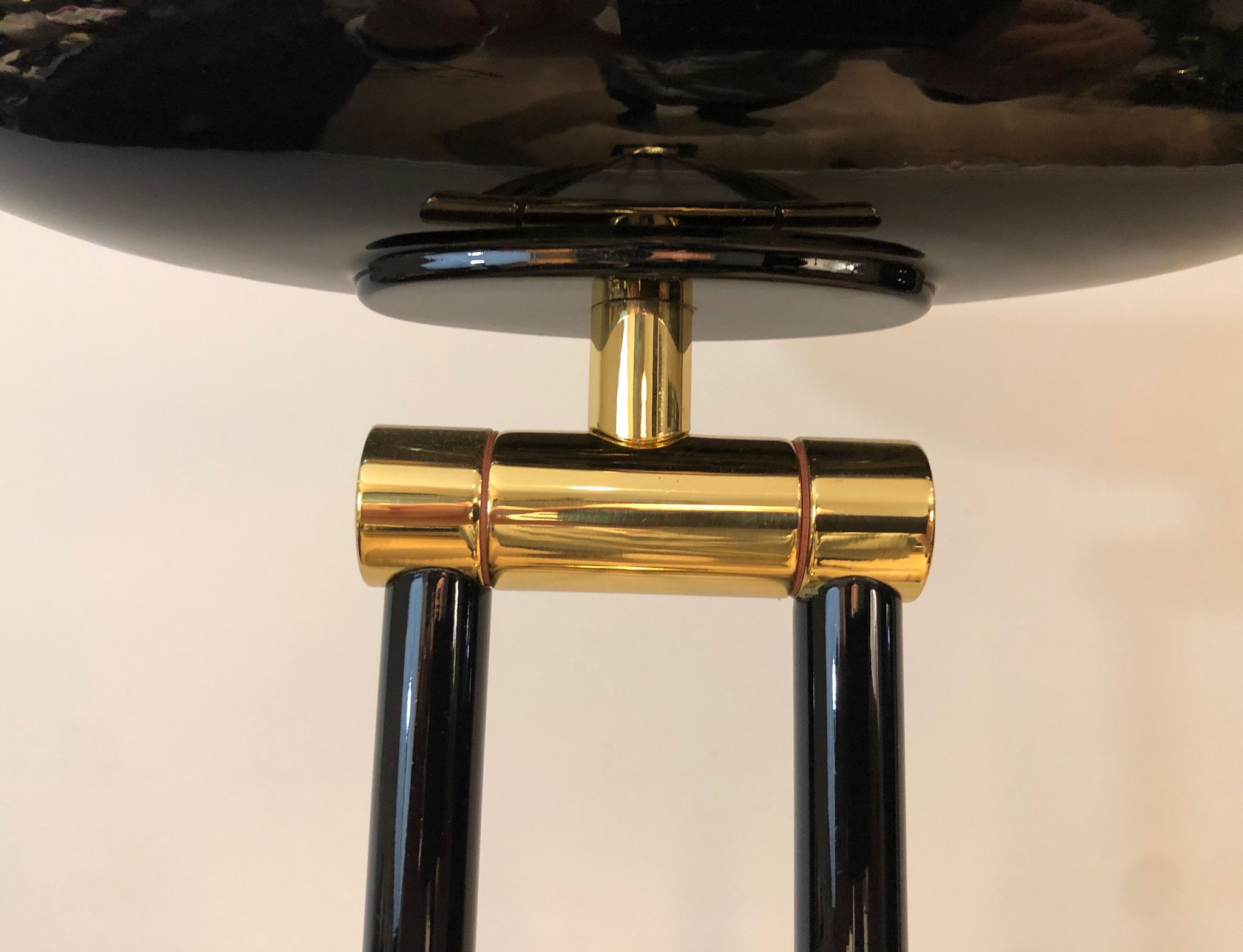 Black lacquered metal floor lamp with brass.