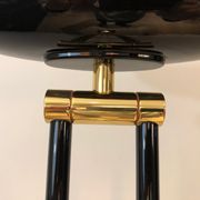 Black lacquered metal floor lamp with brass.