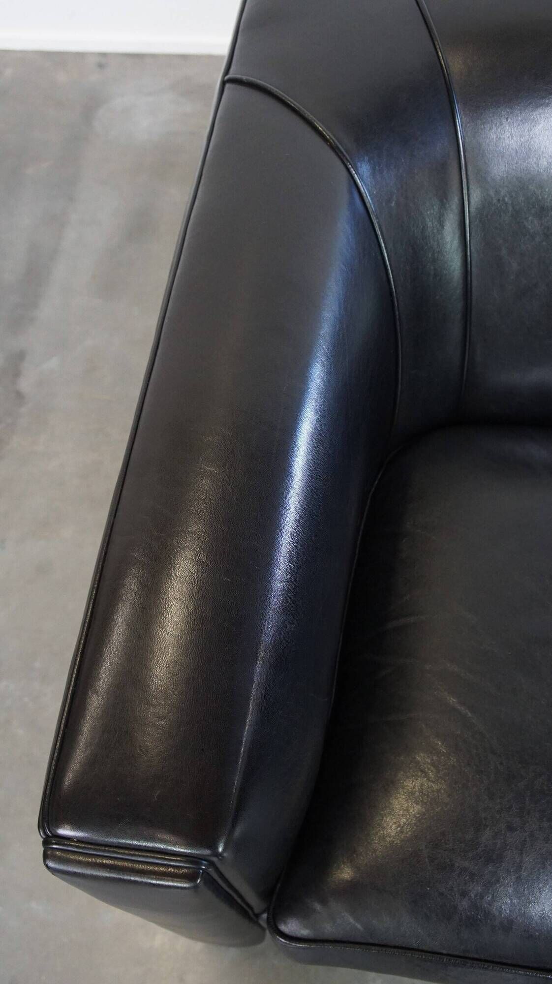 Very comfortable black Art Deco design armchair, made of sheepskin leather