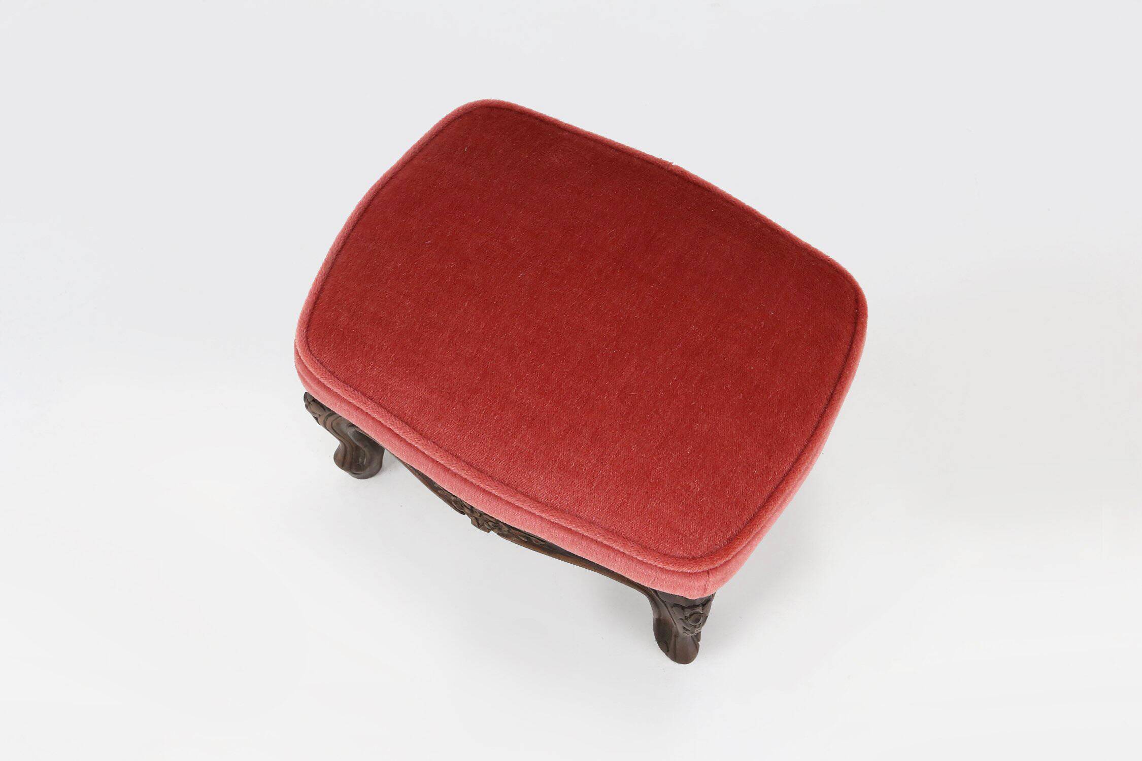 Baroque style foot stool in carved wood with coral velvet upholstery