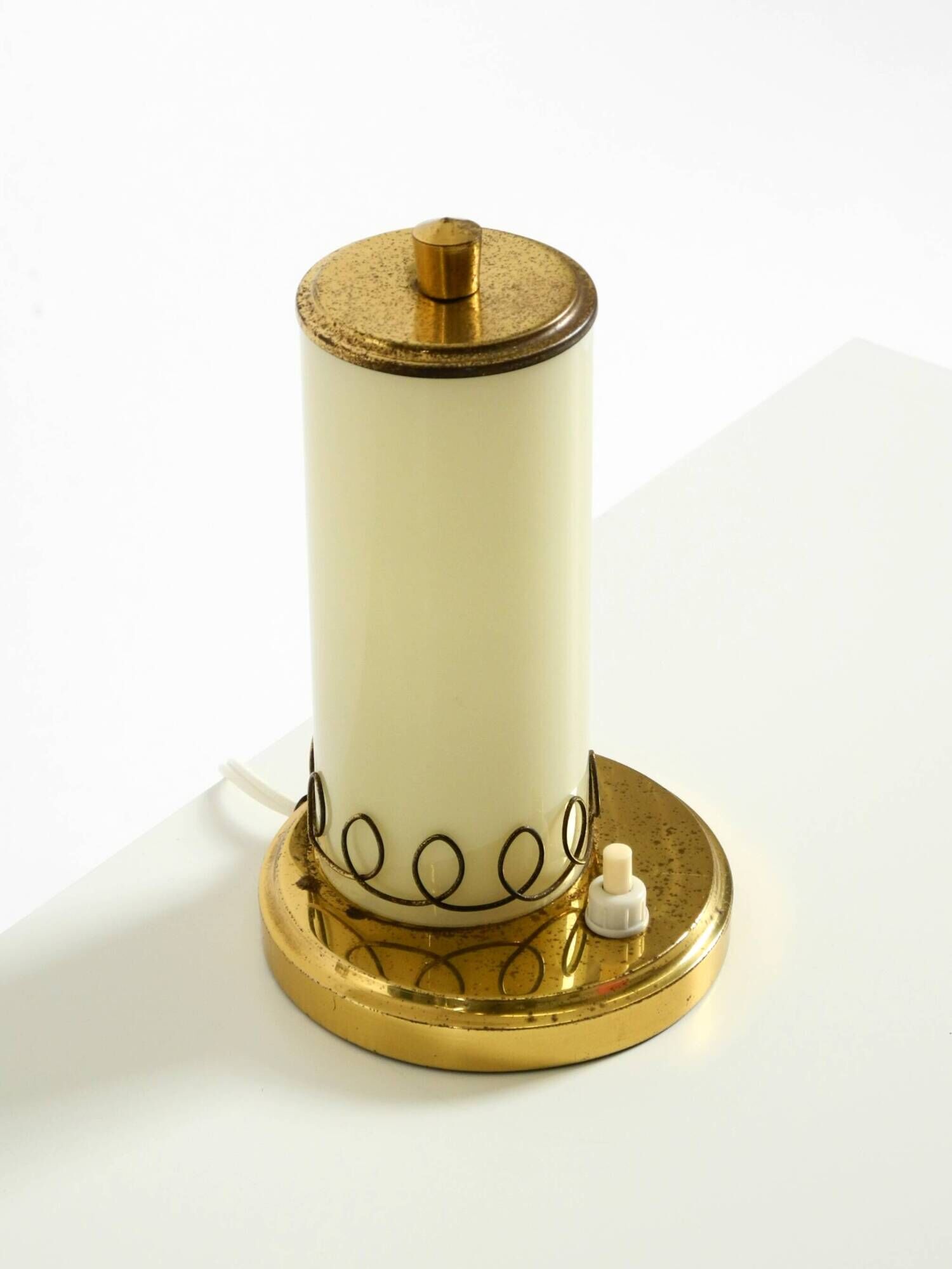 A beautiful, rare 1950s brass table lamp with one opal glass shade adorned